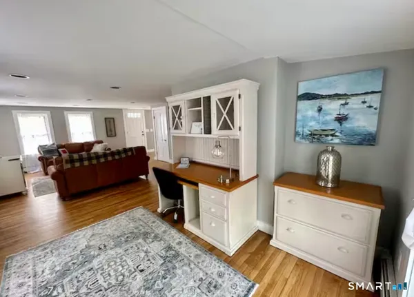 a living room with furniture and paintings on the wall