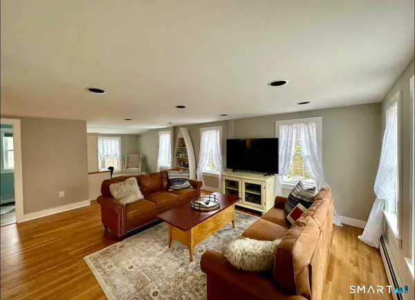 a living room with furniture and a flat screen tv