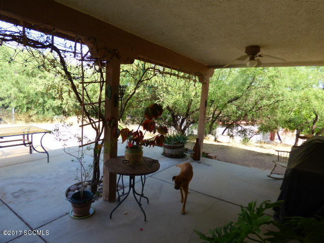 1403 Jeronimo Court Rio Rico, AZ 85648 - Photo 2 of 9 a view of a porch with chairs and a yard