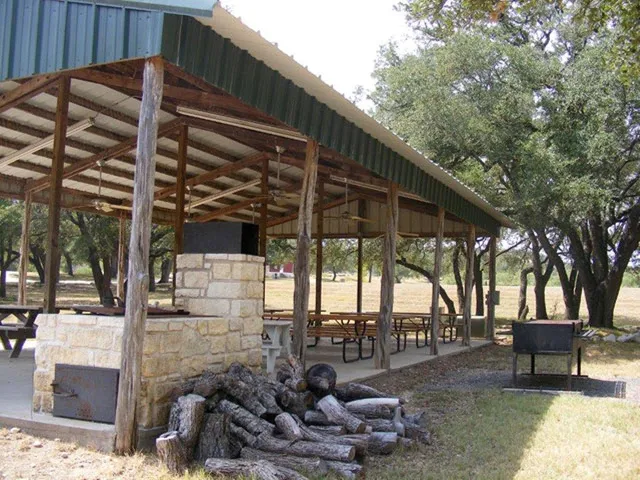 a backyard of a house with barbeque oven table and chairs