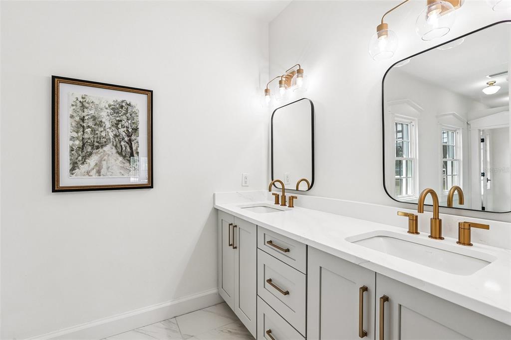 1012 Morfield Lane Brandon, FL 33511 - Photo 54 of 100 a bathroom with a double vanity sink and a mirror