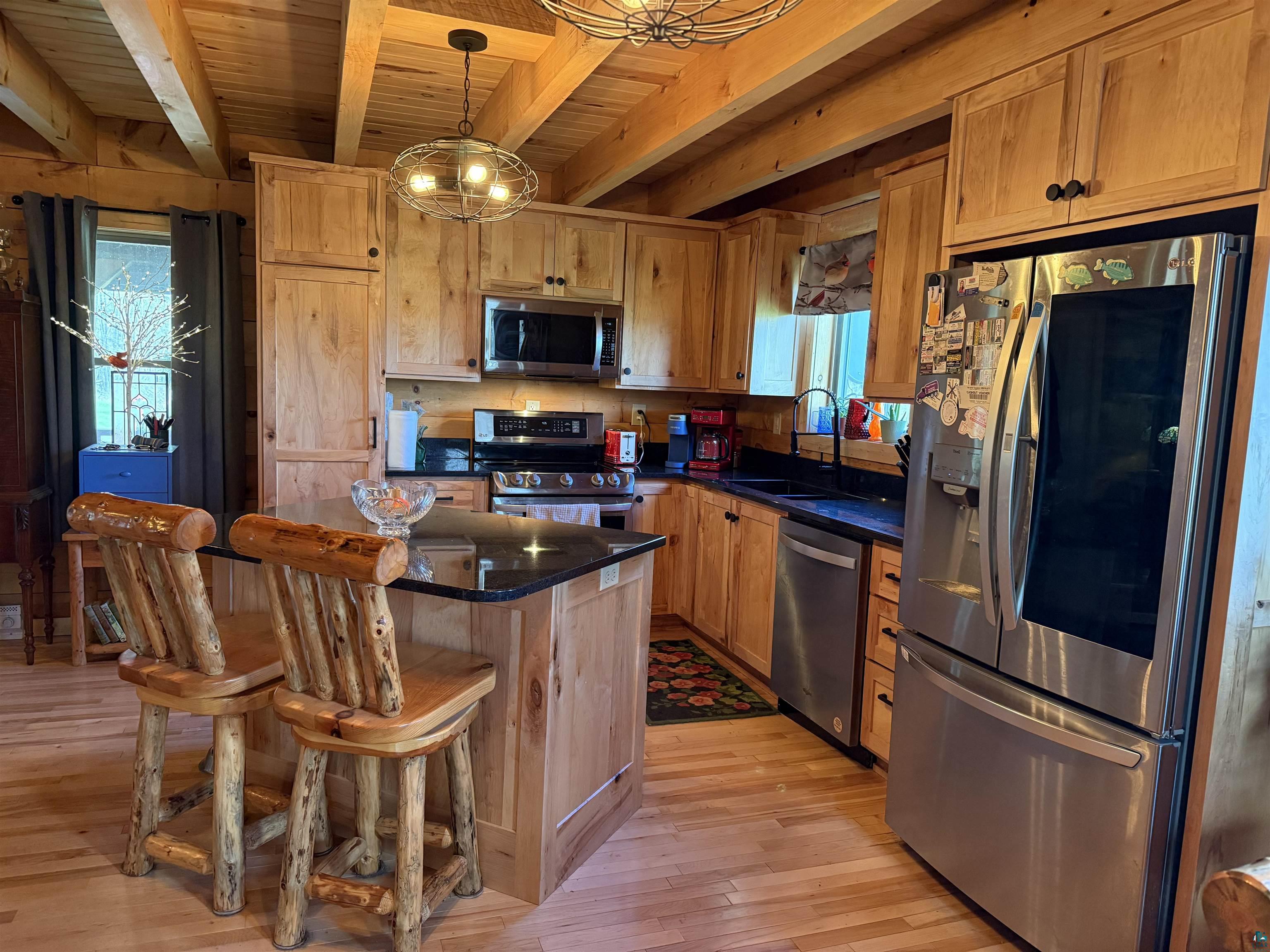 37590 Degerstrom Road Askov, MN 55704 - Photo 7 of 53 Kitchen featuring wood-finish flooring and exposed beam ceiling