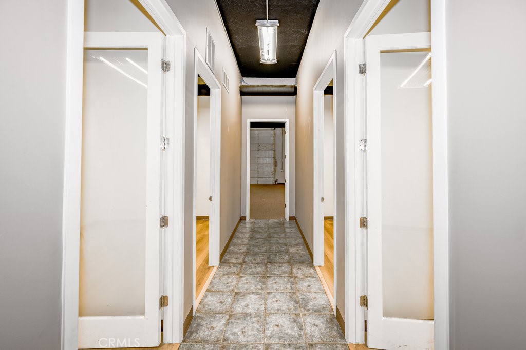 24609 Arch Street Newhall, CA 91321 - Photo 7 of 23 hallway with doors to 5 offices and large warehouse