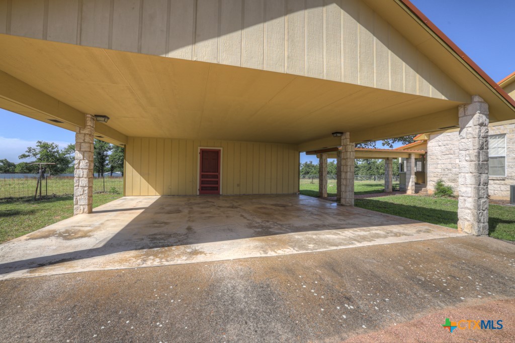 82 Bell Mountain Road Willow City, TX 78675 - Photo 7 of 41 a view of a house with a yard and garage