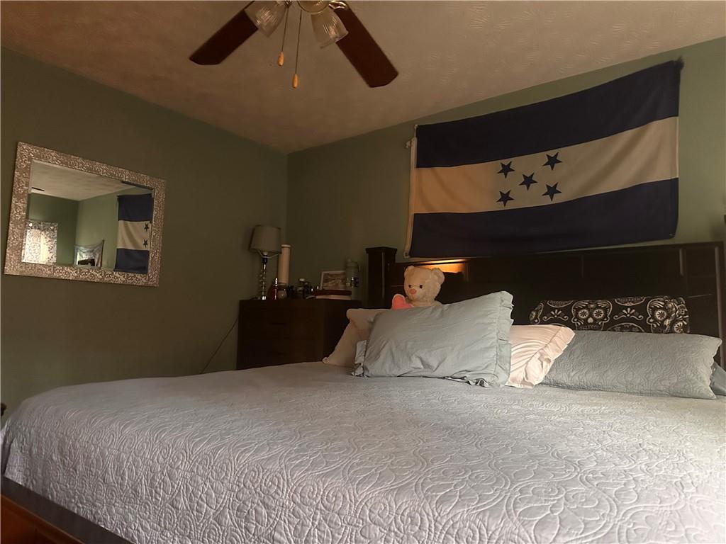 1637 Roman Point Drive Norcross, GA 30093 - Photo 12 of 21 a bedroom with a bed and a lamp