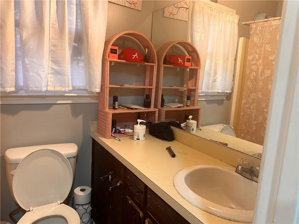 1637 Roman Point Drive Norcross, GA 30093 - Photo 19 of 21 a bathroom with a sink and mirror with toilet