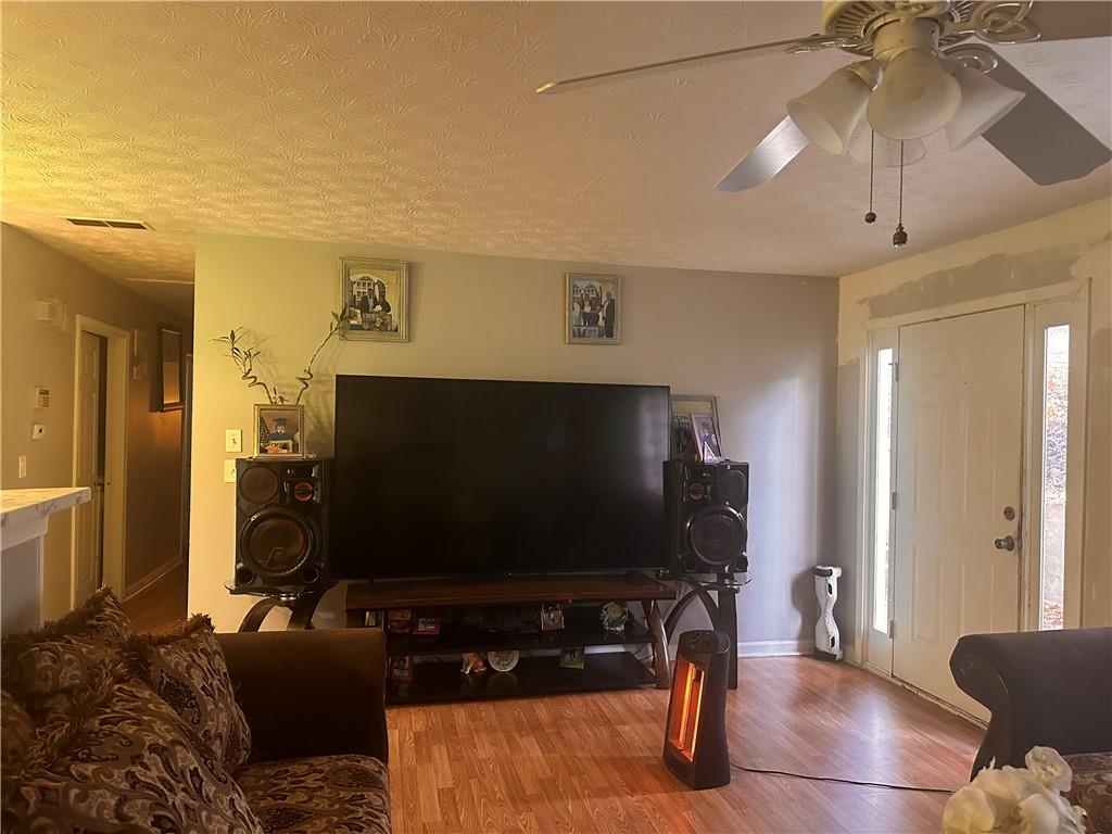 1637 Roman Point Drive Norcross, GA 30093 - Photo 7 of 21 a living room with furniture and a flat screen tv
