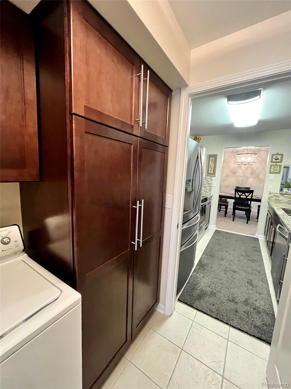 3624 Oakmonte Boulevard, Unit 82 Rochester, MI 48306 - Photo 25 of 37 Laundry area featuring washer / clothes dryer and light tile patterned flooring