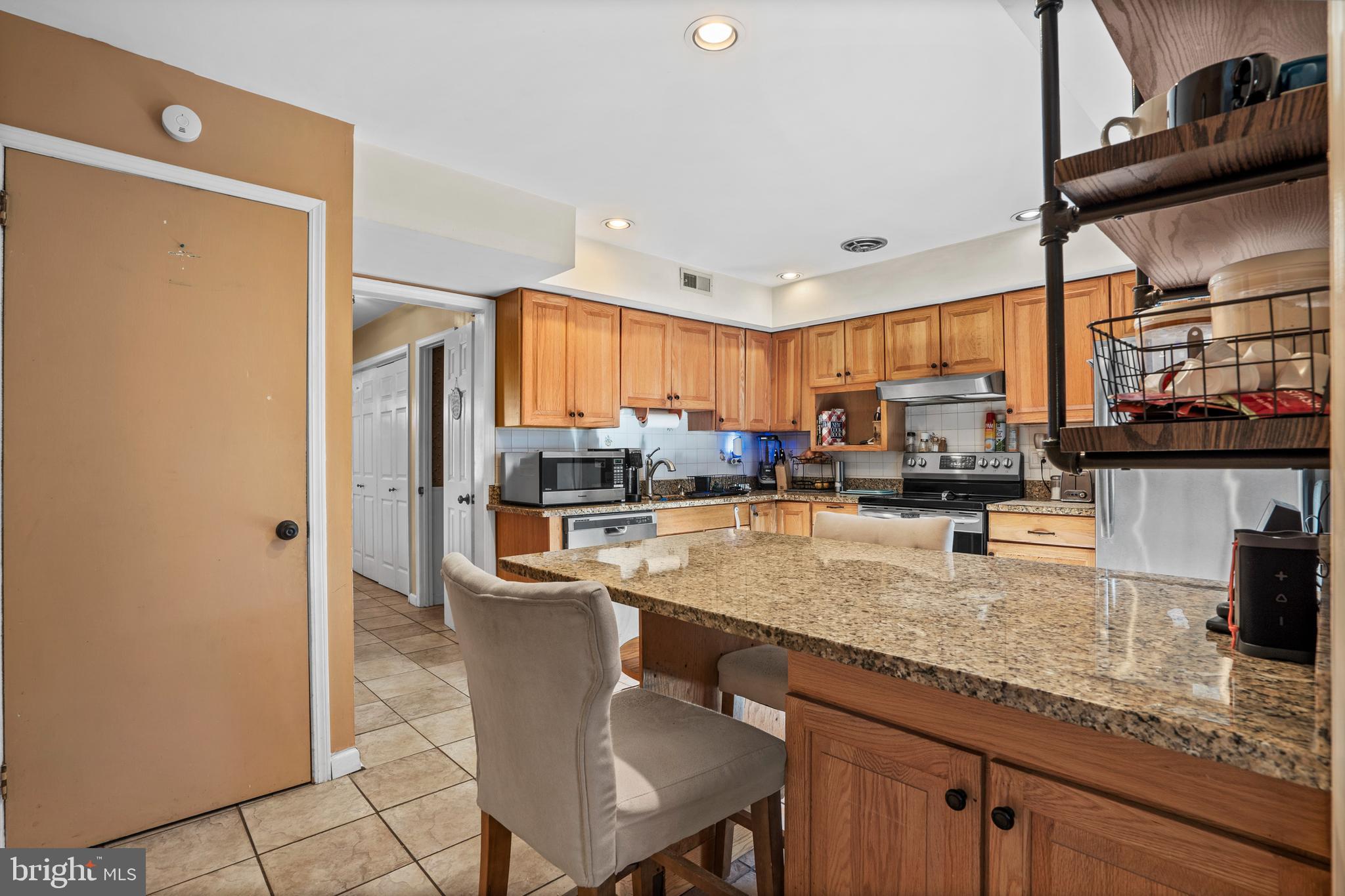 18 Essex Lane Langhorne, PA 19047 - Photo 15 of 50 a kitchen with stainless steel appliances granite countertop a sink refrigerator and cabinets
