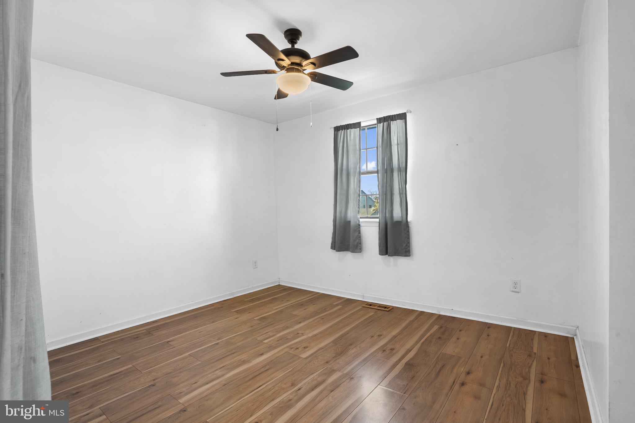 18 Essex Lane Langhorne, PA 19047 - Photo 33 of 50 an empty room with wooden floor and ceiling fan