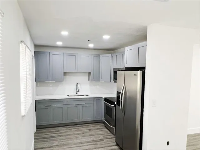 a kitchen with stainless steel appliances granite countertop a refrigerator sink and cabinets