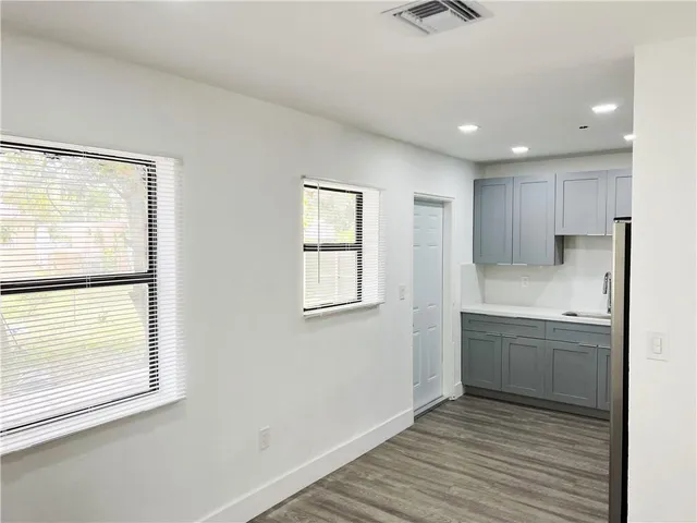a bathroom with a sink mirror and a shower