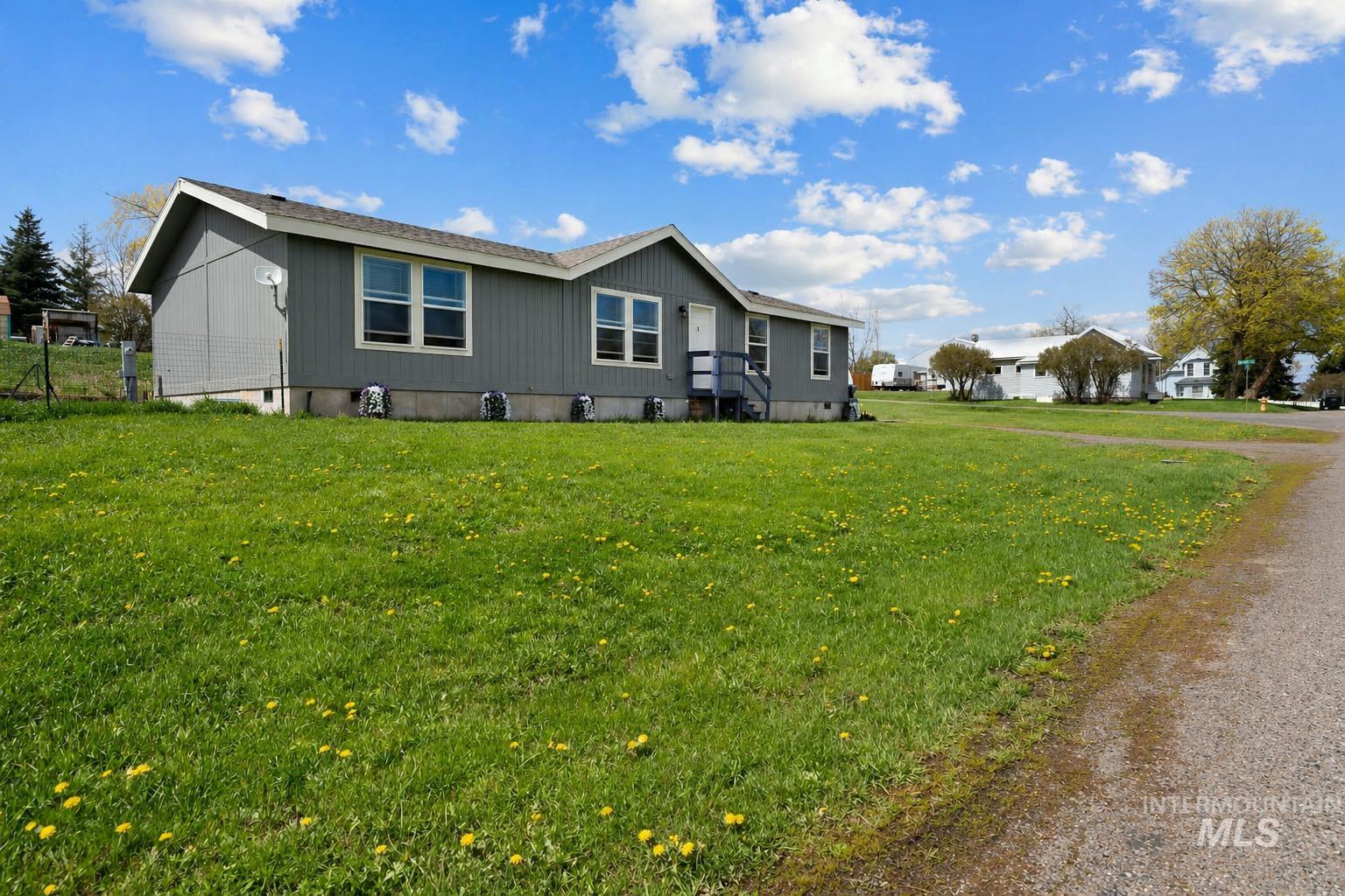 302 3rd Avenue Craigmont, ID 83523 - Photo 31 of 31 Single-story residence featuring a gray exterior with white trim windows and a light gray shingle roof
