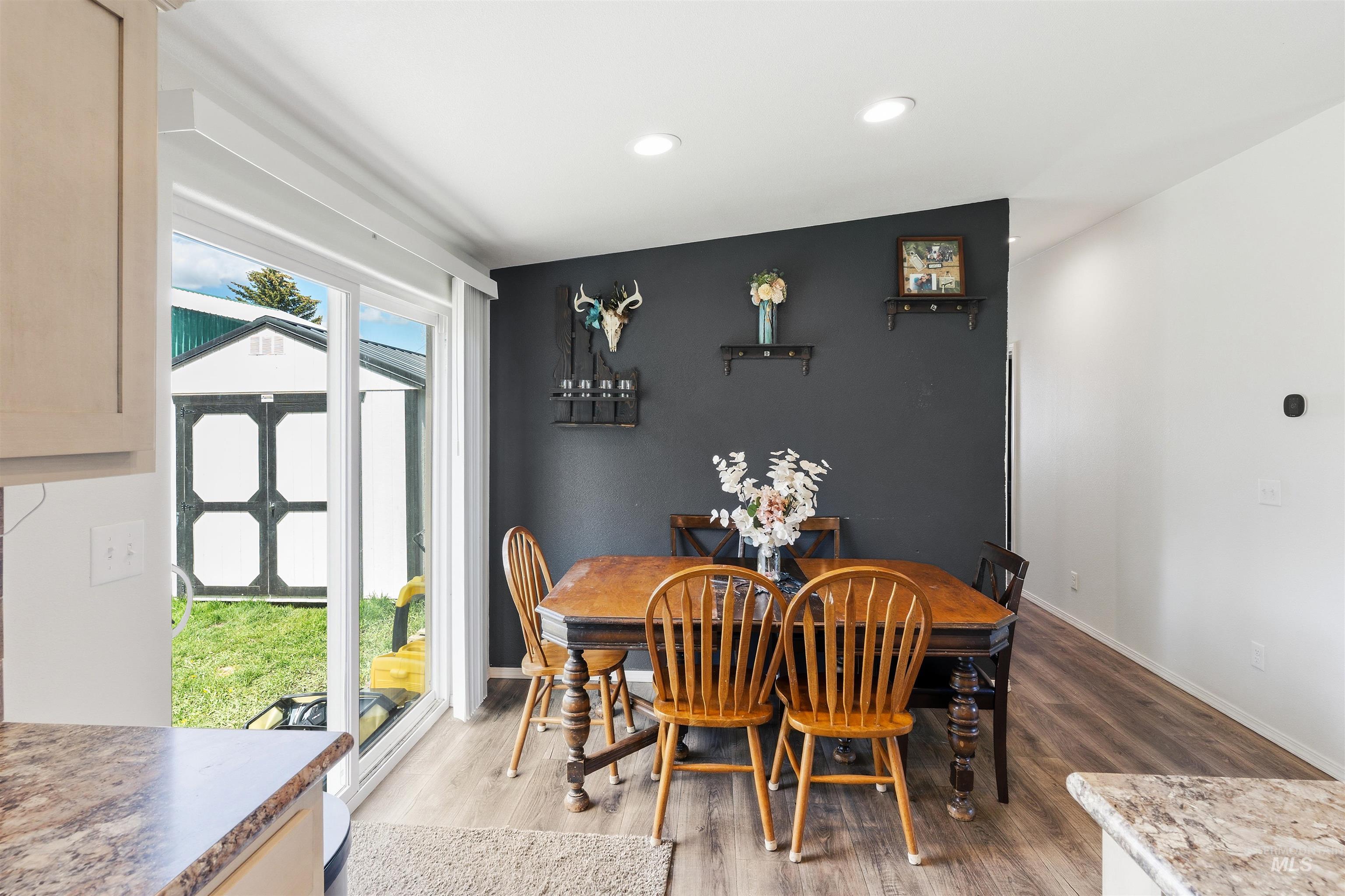 302 3rd Avenue Craigmont, ID 83523 - Photo 6 of 31 Dining area featuring a dark accent wall, recessed lighting, and wood-finish flooring