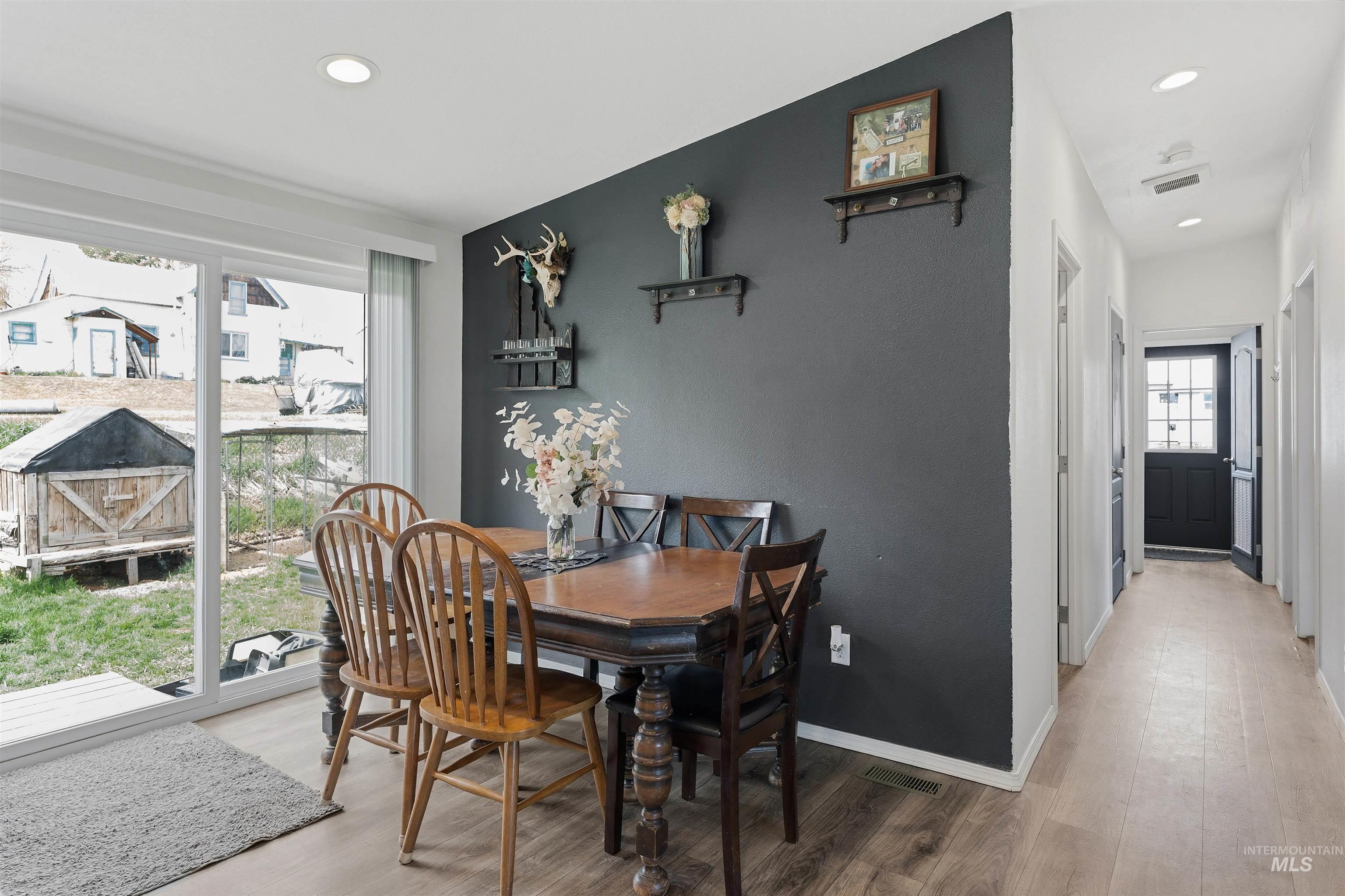 302 3rd Avenue Craigmont, ID 83523 - Photo 7 of 31 Dining area featuring wood-finish flooring, a contemporary accent wall, and recessed lighting