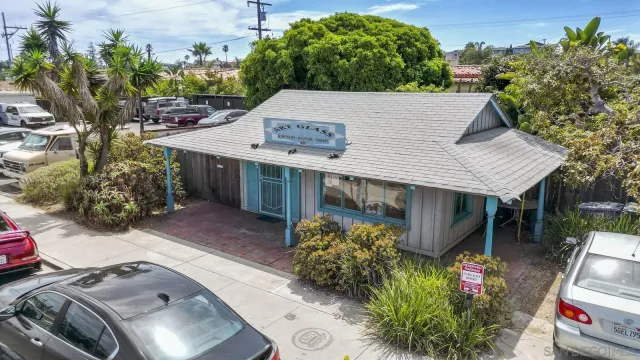 a terrace with a table and chairs and potted plants