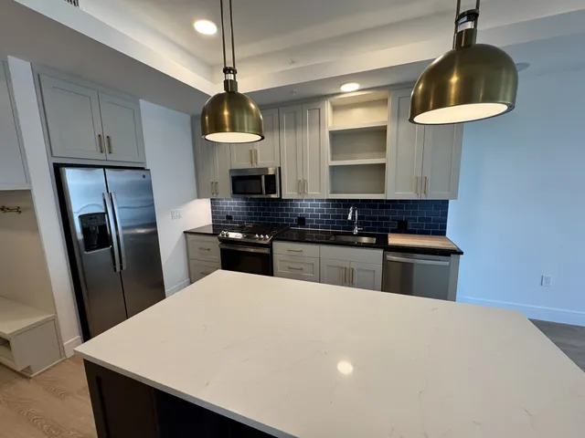a kitchen with a refrigerator and a sink