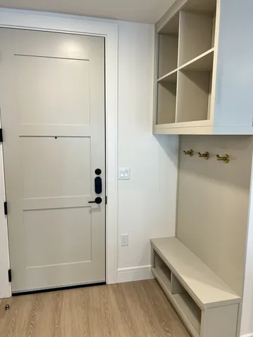 an empty room with wooden floor and a window