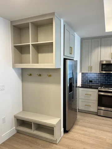 a kitchen with stainless steel appliances a stove a sink and a refrigerator