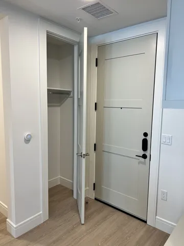 a kitchen with white cabinets and window