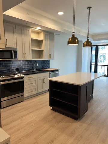 a kitchen with a sink a stove and cabinets
