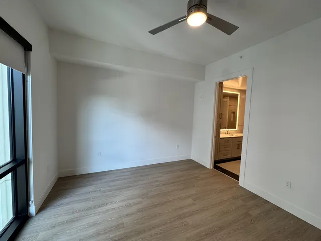 a kitchen with a refrigerator stove and wooden floor