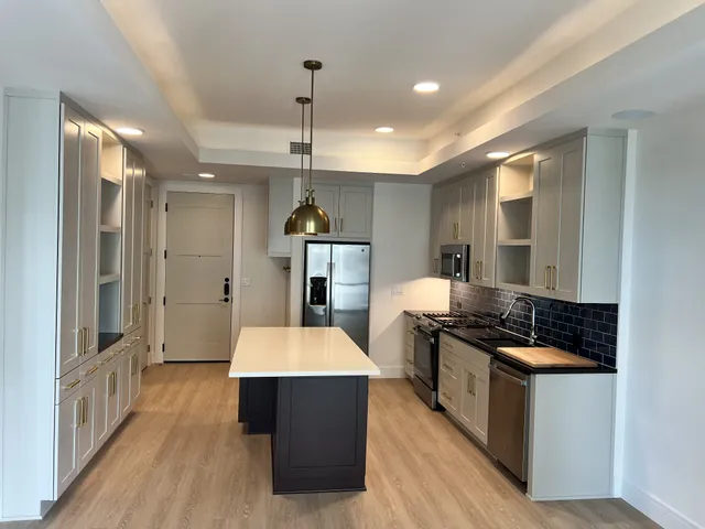 a bathroom with a double vanity sink toilet mirror and bathtub