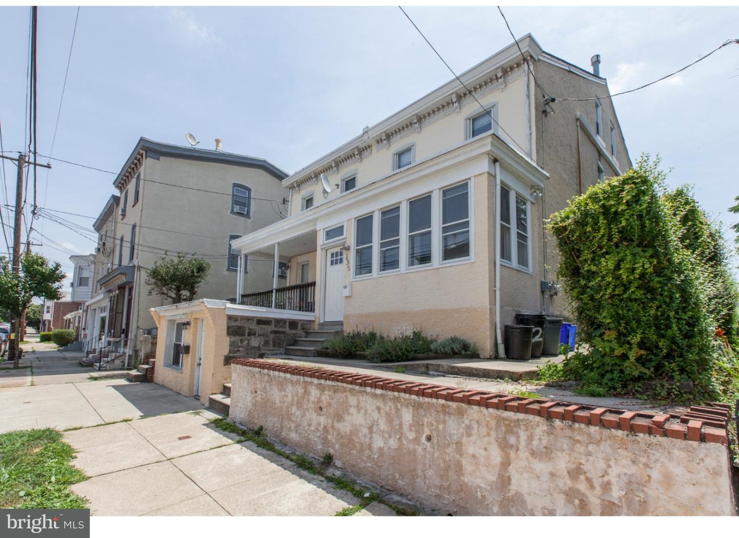 235 Roxborough Avenue Philadelphia, PA 19128 - Photo 2 of 22 a view of a white building among the street with palm trees