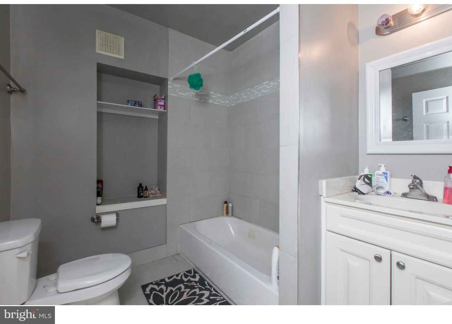 235 Roxborough Avenue Philadelphia, PA 19128 - Photo 11 of 22 a bathroom with a sink a toilet and a mirror