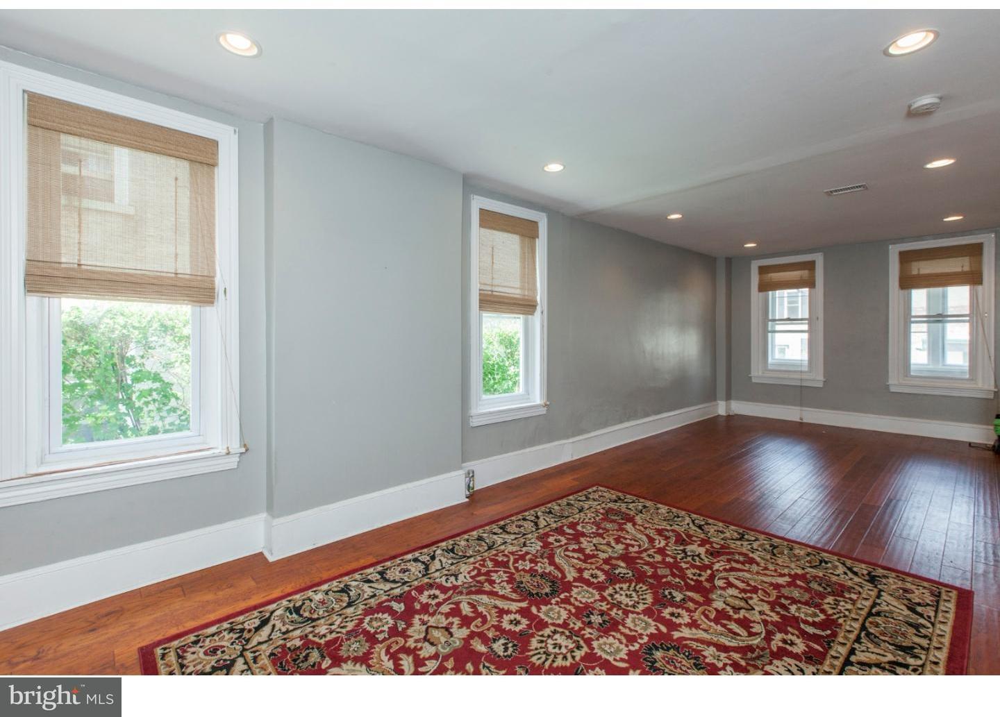 235 Roxborough Avenue Philadelphia, PA 19128 - Photo 6 of 22 an empty room with wooden floor and windows