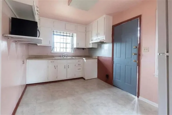 a view of a kitchen with electric appliances