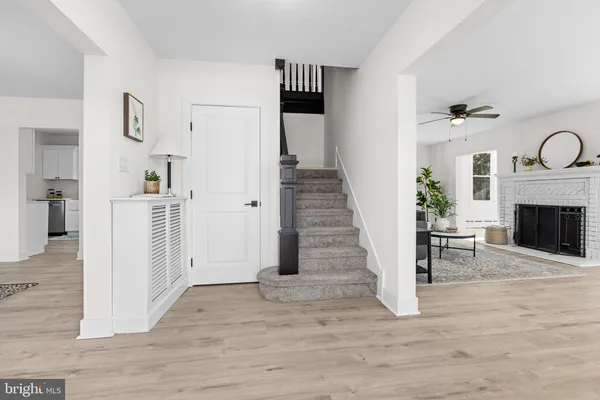 a view of a livingroom with wooden floor and fireplace