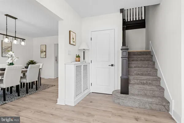 a view of a hallway with wooden floor and entryway