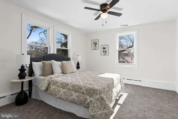a bedroom with bed and wall painting