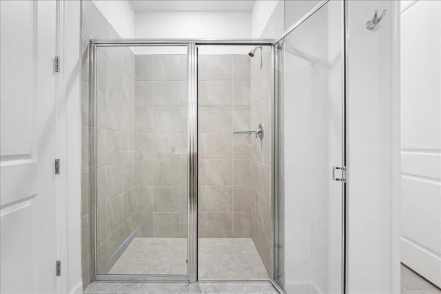 a bathroom with a glass shower door
