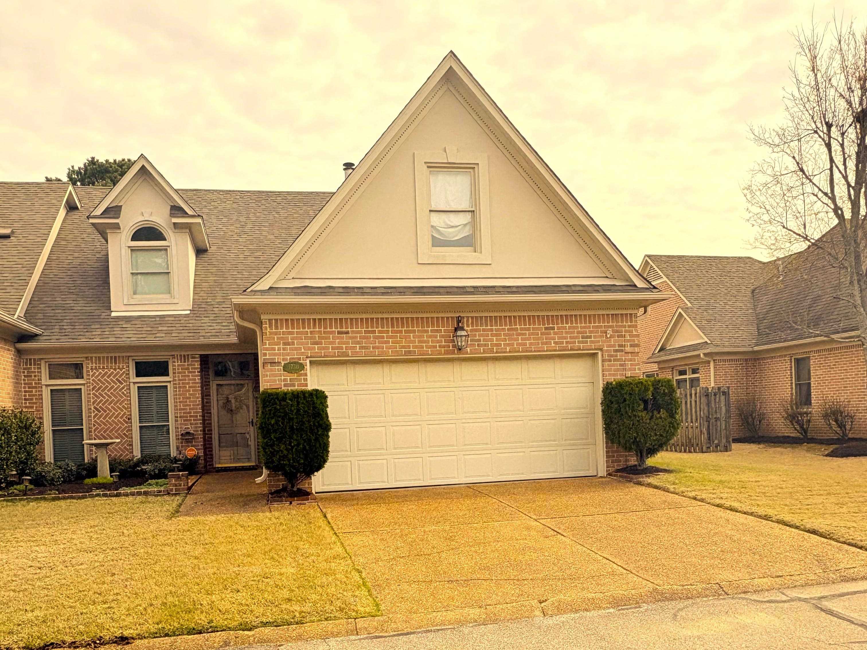 1730 Gosnold Bluff Road Collierville, TN 38017 - Photo 1 of 15 View of front of house with brick siding, a garage, driveway, a shingled roof, and a front yard
