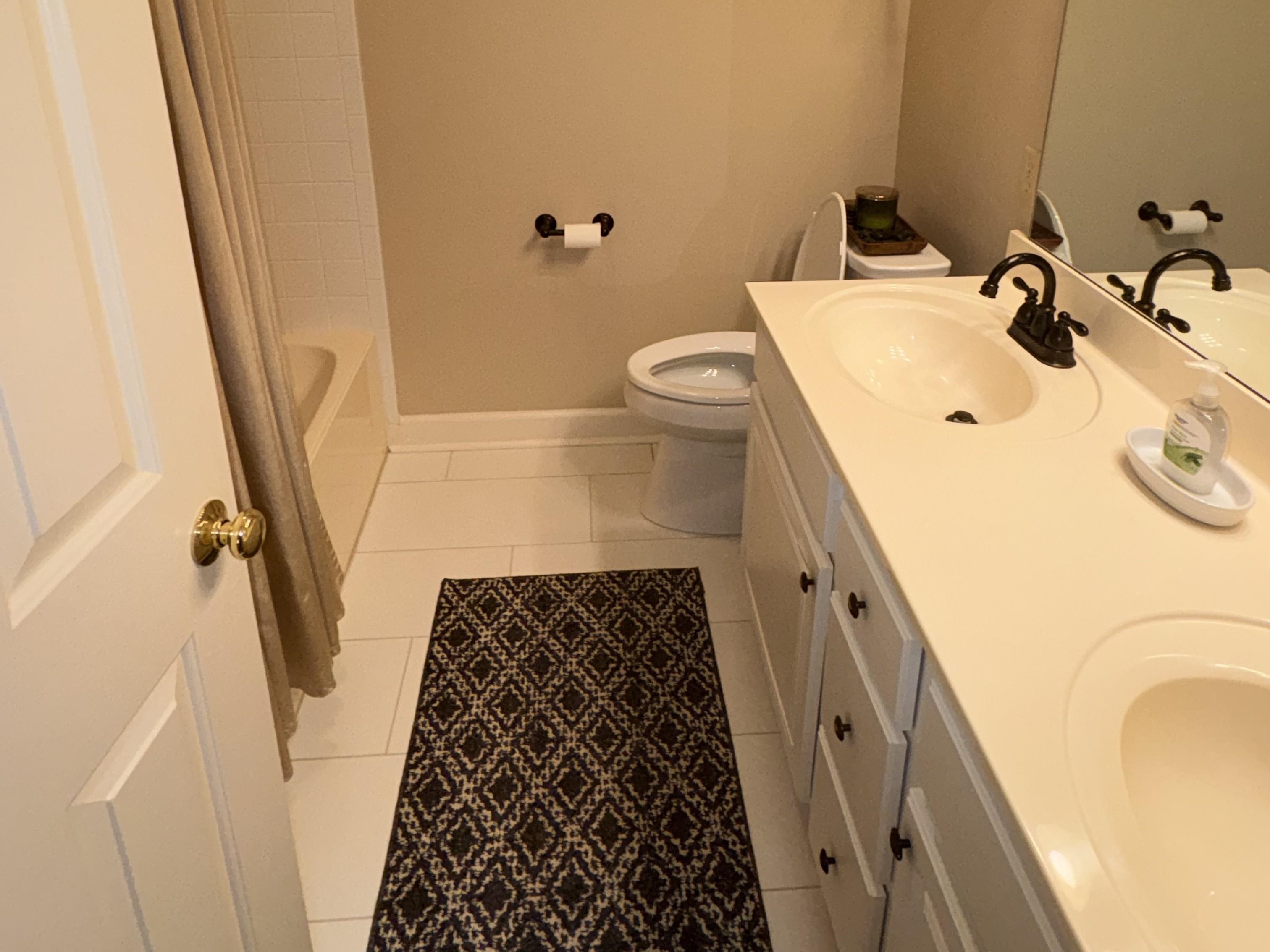 1730 Gosnold Bluff Road Collierville, TN 38017 - Photo 13 of 15 Full bath with double vanity, light tile patterned flooring, and shower / bath combination with curtain