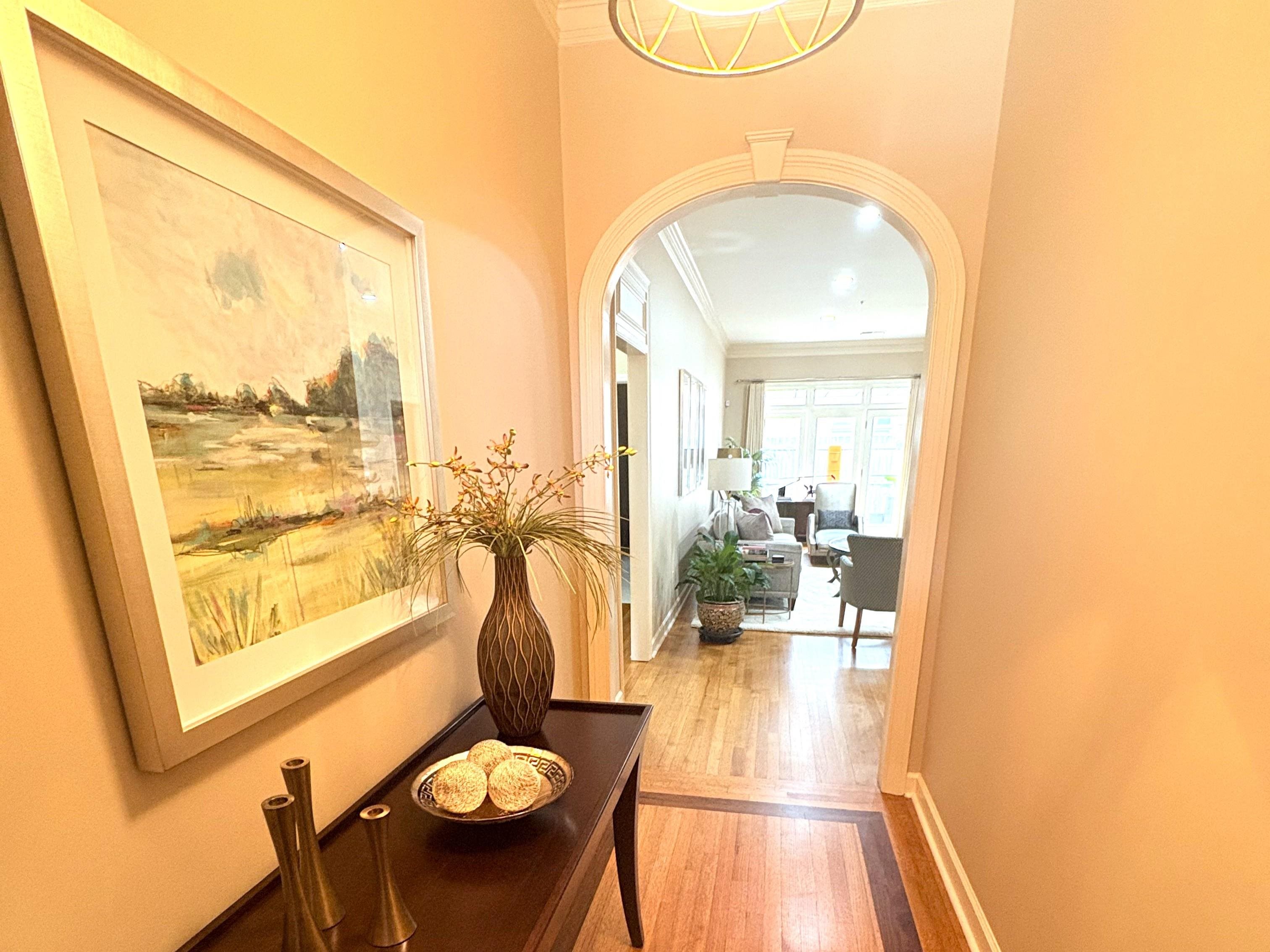 1730 Gosnold Bluff Road Collierville, TN 38017 - Photo 2 of 15 Corridor with arched walkways, ornamental molding, and light wood finished floors