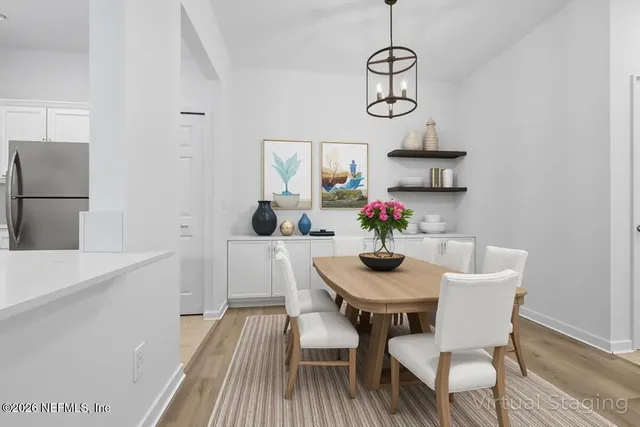 a view of a dining room with furniture wooden floor and a chandelier