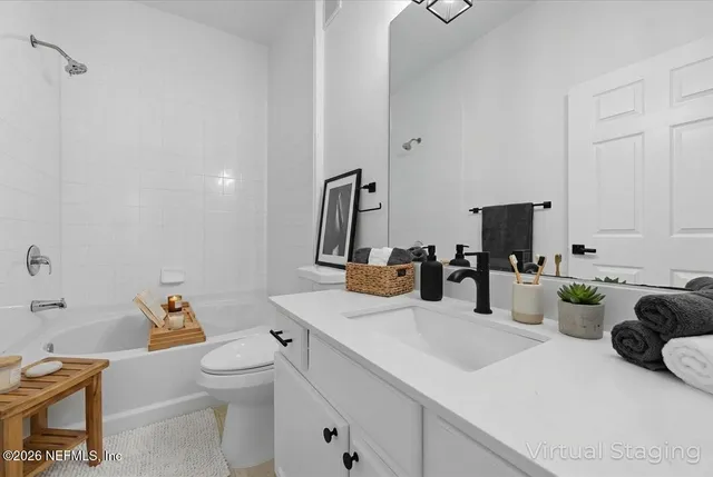 a bathroom with a sink double vanity and a toilet