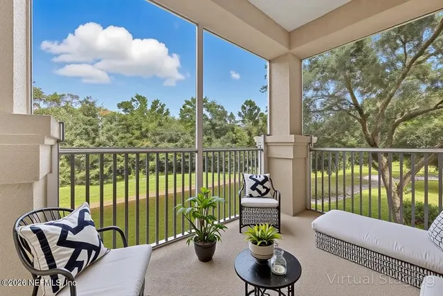 a balcony with furniture and a potted plant