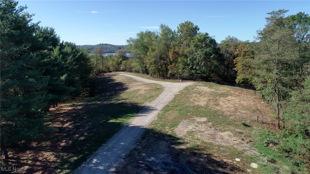 23305 Lashley Road Senecaville, OH 43780 - Photo 17 of 17 View of dirt / gravel road featuring a view of trees