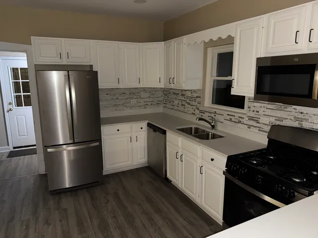 a kitchen with a sink stove and refrigerator