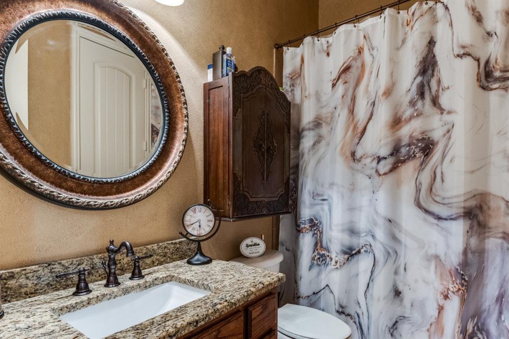 2810 Baker Street Sachse, TX 75048 - Photo 20 of 26 Bathroom with a textured wall, a shower with curtain, and vanity
