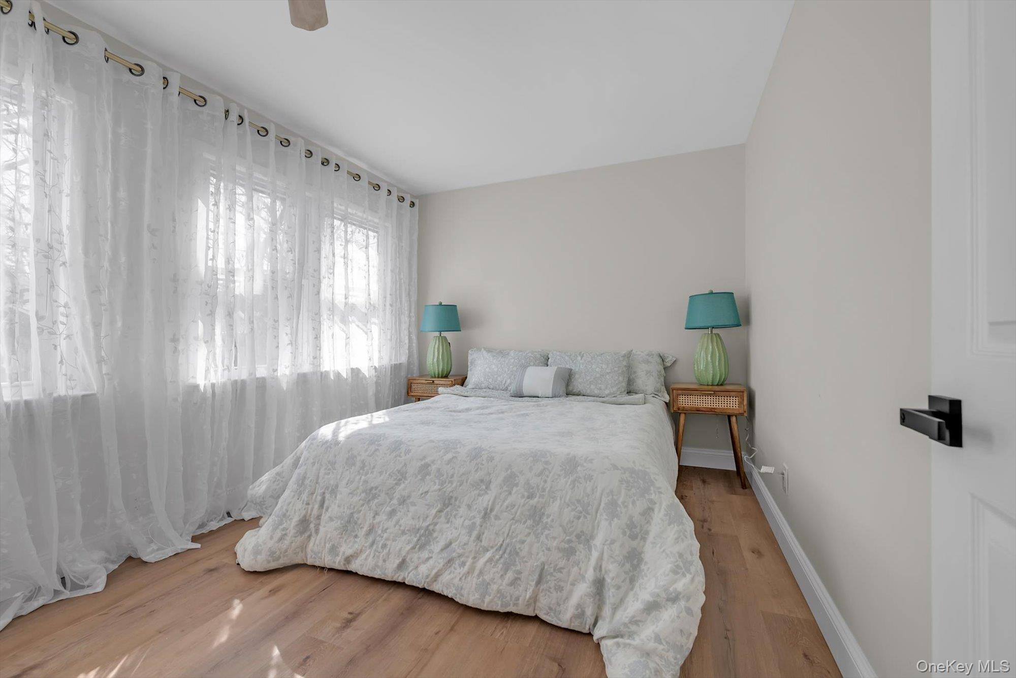 31 Walters Avenue Syosset, NY 11791 - Photo 15 of 29 a bedroom with a bed and a window