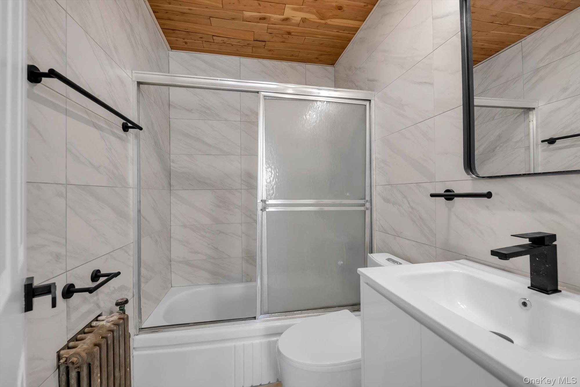 31 Walters Avenue Syosset, NY 11791 - Photo 21 of 29 a bathroom with a sink a toilet and shower