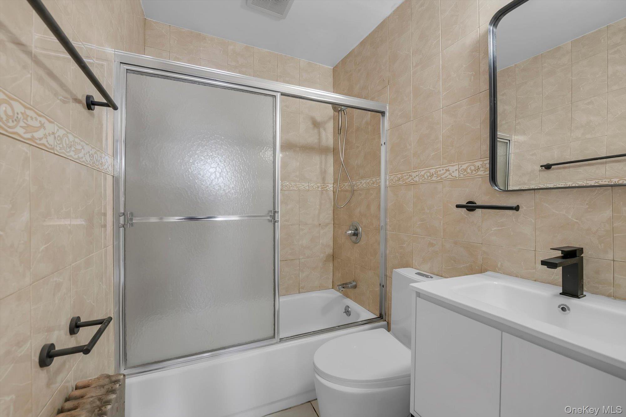 31 Walters Avenue Syosset, NY 11791 - Photo 22 of 29 a bathroom with a shower a sink a toilet and shower
