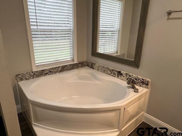 174 County Road 2604 Pittsburg, TX 75686 - Photo 6 of 22 a bathroom with a bathtub and window