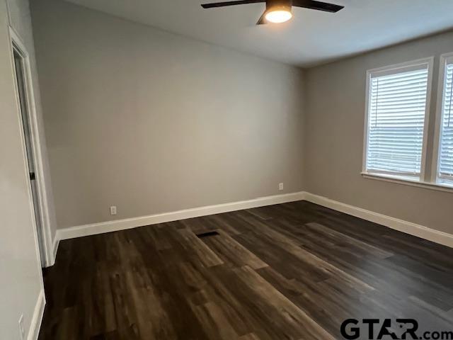 174 County Road 2604 Pittsburg, TX 75686 - Photo 9 of 22 an empty room with wooden floor and windows