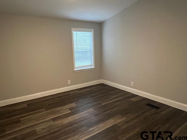 174 County Road 2604 Pittsburg, TX 75686 - Photo 10 of 22 a view of an empty room with wooden floor and a window